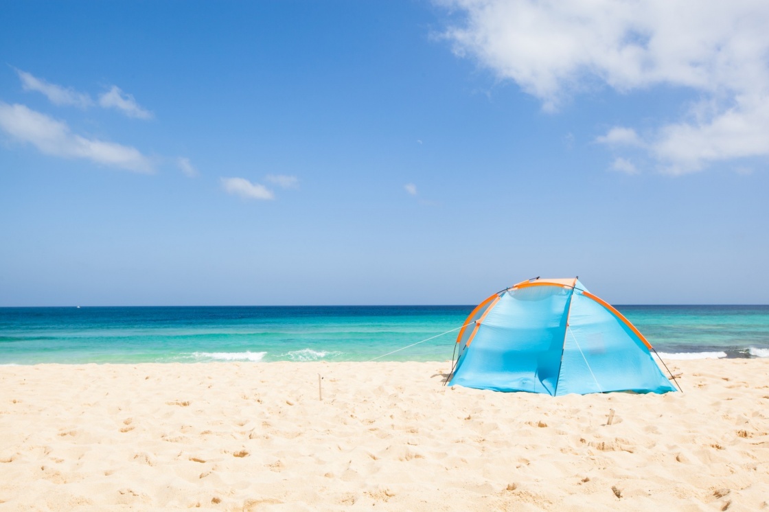 'camping with a tent at a lonesome beach with a turquoise sea and blue sky in the background, Fuerteventura, Canary Islands, Spain, Europe' - Isole Canarie